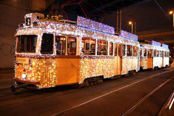 the yellow tram 2 in festive lighting at night