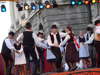a folk dance ensemble on the stage of the festival