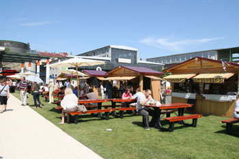 people sitting at wooden table on the Gourmet Festival in Millenaris park