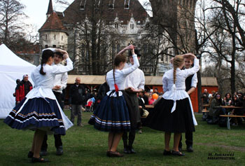 folk dancing in front of Vajdahunyad castle