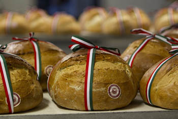 a round-spahe bread with a national tricolor ribbon tied on it - 20. August