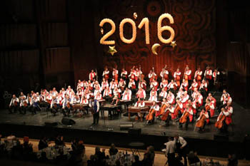 the gypsy orchestra playing, 2016 written on the wall in the background