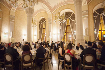 people having festive NYE dinner in an elegant arcaded dining hall