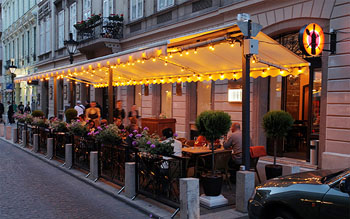 the tented terrace illuminated at dusk