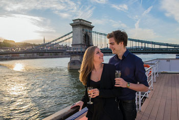 a young couple sipping wine on a boat on the Danube
