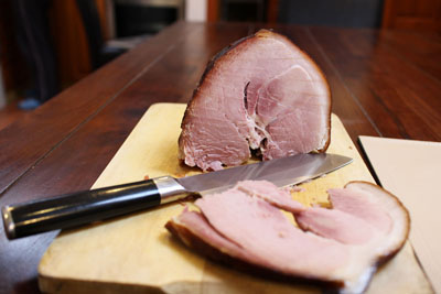 cooked smoked ham on a cutting board