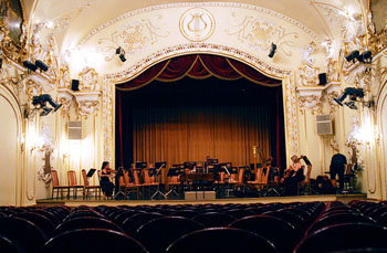 an orchestra playing on the stage of the Danube Palace's concert hall