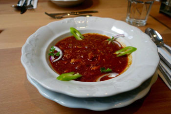 goulash soup in a white plate in Gettó Gulyás restaurant