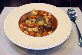 goulash soup in a beige soup bowl