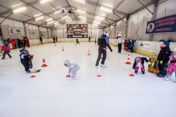 skaters on the ice rink in Buda