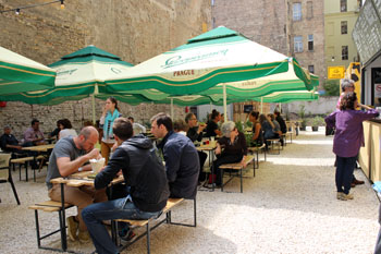 people eating at wooden tables in Karaván