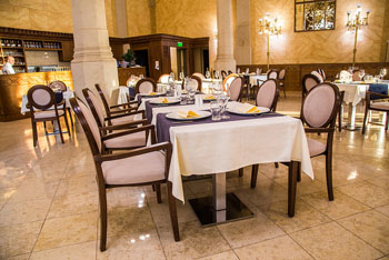 the elegant interior of the Pesti vigado resturant with white clothed tables