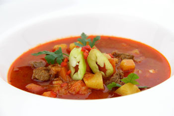 goulash soup serve din a white plate