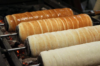 four rolls of Sekler cake baking over coal