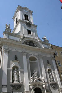 the white-grey facade of the church and its tower