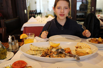 our older son eating seafood in Trattoria Pomo D'oro
