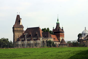 the castle with a green lawn in the foreground