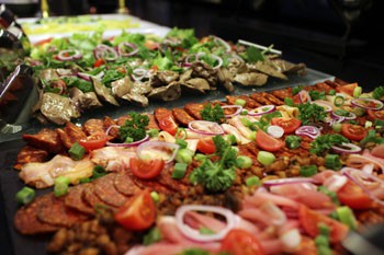 Hungarian paprika salami, roasted duck liver tomato, green pepper arranged on a serving plate