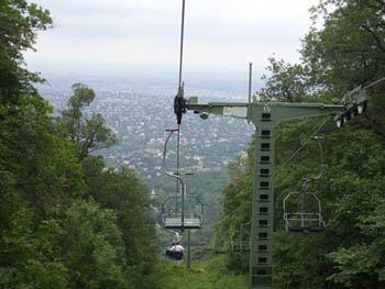 chairlift up on the hills with view of the green valley below