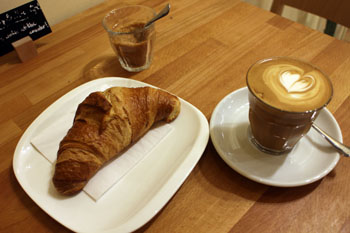 flat white and croissant in Madal Espresso Shop