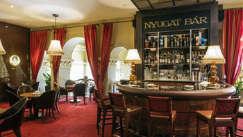 wine red carpet and a dark wood bar in Nyugat bar