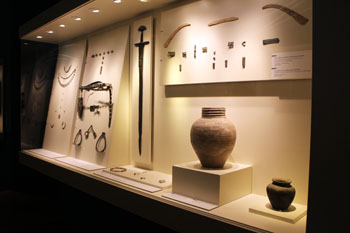 urns, weapoms, jewelry from the ancient times of the city displayed in glass cabinets