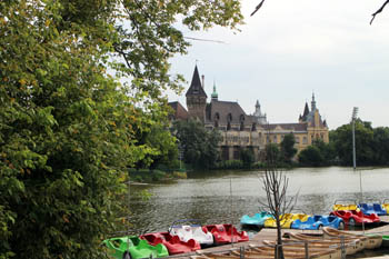 colorful rowing boat in the lake, vajdahunyad castle in the background