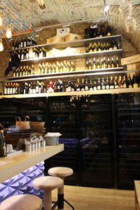 shelves stocked with wine in the vaulted DOC wine Bar in downtown Pest