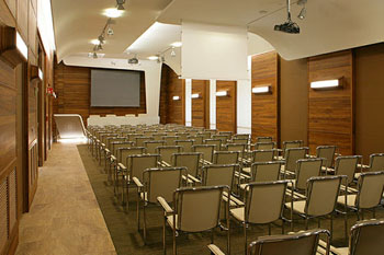 rows of chairs i the wood-paneled conference room