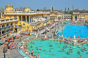 bird's eye view of the outdoor pools and the yellow building