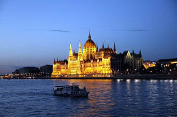 a crusie boat Danube at the Parliament at the blue hour 