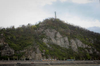 the hill with the Liberty Statue on its top on a cloudy day