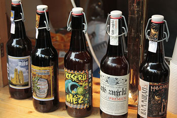 5 bottled craft beers on a wood table