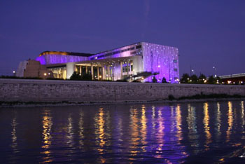 the Palace of Arts illuminated in purple at night