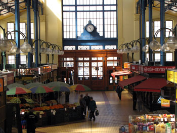 the interior of the market with a clock above the entrance door