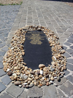 the black marble memorial of Raoul Wallenber surrounded with stones left by visitors