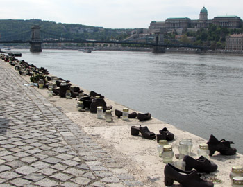 pairs of old-fashione dcats iron shoes on the danube bank, Chain bridge and Bud aPalac ein the background