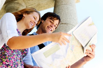 a young tpurist couple looking at a city map