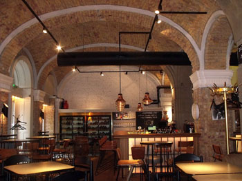 the vaulted brick walled interior of innio bar