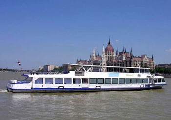 a white tour boat on the Danube at the Parliament