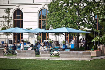 people sitting on the terrace of Kiosk with blue tents
