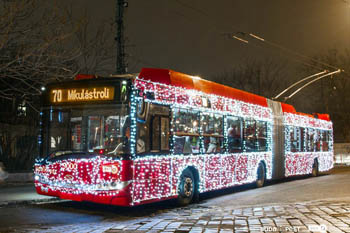 a red trolley bus No. 70 with strings of LEdD lights