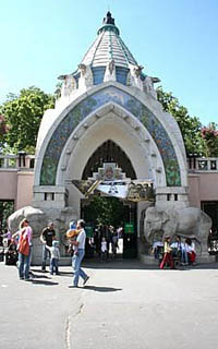 The arched gate of the zoo with a stone elephant statue at each side