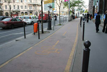 a dark red tarrmac cycle lane with yellow borderline in the city centre