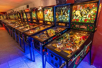 a dozen of pinball machines in the Pinball Museum in Budapest