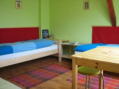 an attic room in 7x24 hostel with lime green walls