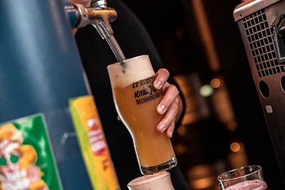 a woman drawing beer in a festival mug