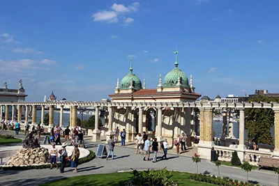 The palaces with 2 green cupols and the promenade with people walking