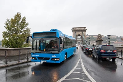 A blue public transport bus on the Chain Bridge