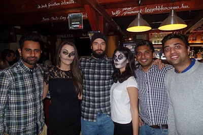 4 guys and 2 girls in a club, the girls wear Halloween makeup